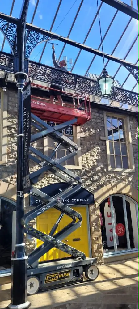 Cleaning a shopping centre glass roof from a scissor lift