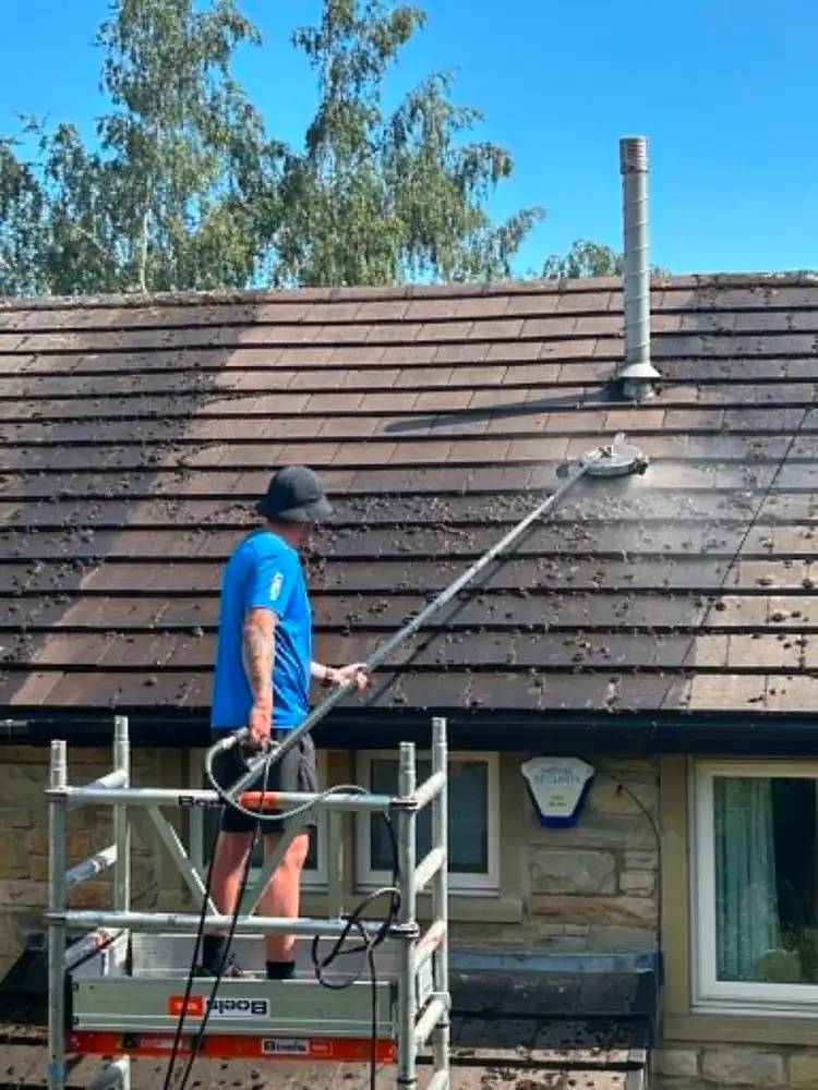 Roof cleaning with pressure washing equipment