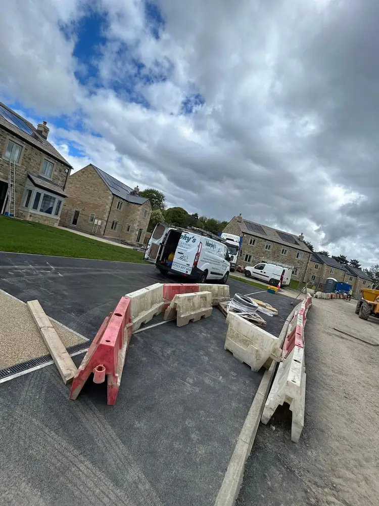 Builders clean on construction site houses with solar panels